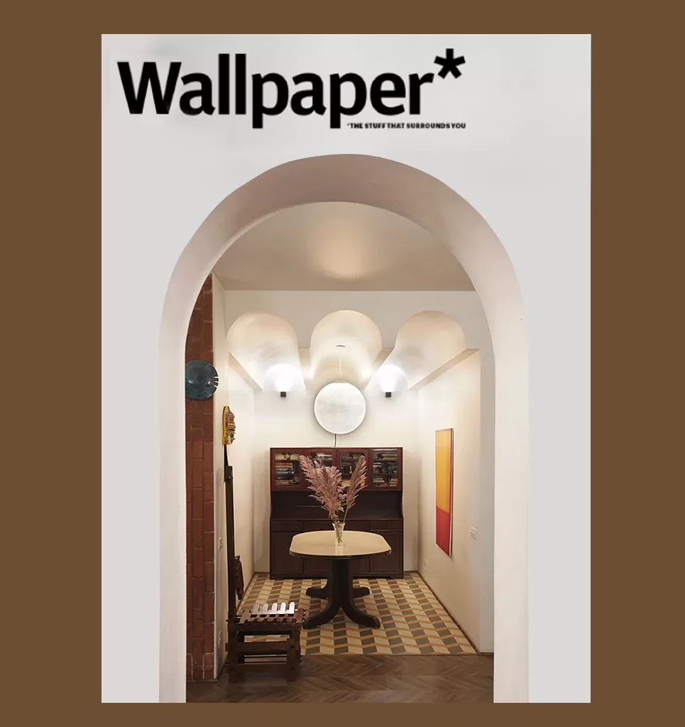 Wallpaper magazine feature showing an arch opening towards the dining area, soft warm colors, design by NOOR Architects Consultants